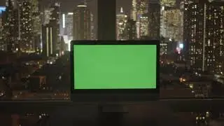 computer screen covered with green background in modern city office | Video Stocks