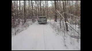 Following a 1976 Jeep Cherokee SJ in a 2002 Ski-Doo MXZ snowmobile. Addington Highlands, ON, Canada.