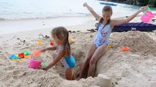Children playing on the beach with sand and toys 4K