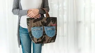 A beautiful bag made from old jeans and military-pattern canvas, with a zipper on the top.