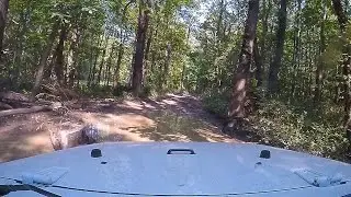 Muddy trail at the Badlands Off Road Park in mostly stock Jeep Wrangler JK Sahara 4x4