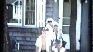 4  Mom with kids at beach and Dad with sunglasses on waving
