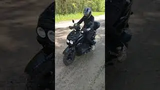 Жена уверенно стартует на скутере.