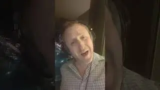 In a hotel room doing a silly experiment with singing slowly and then speeding it up.