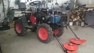 We attach the mower to the walk-behind tractor
