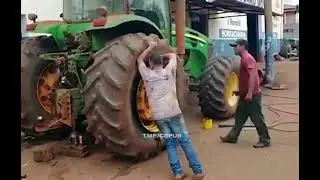 Непростой способ накачать колесо трактора