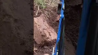 Lifting up massive boulders with New Holland workmaster 25s back hoe