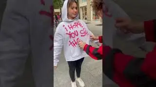 Guy spray paints a message on girl's hoodie!