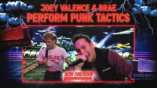 JOEY VALENCE & BRAE perform PUNKTACTICS in front of a video game wall