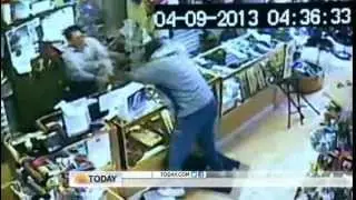 Store owner takes on robbers with baseball bat