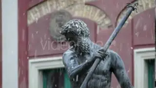 Neptune Bronze Monument Before a Xviii Century Building in Poland With Heavy Snow Falling in Autumn