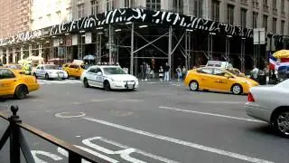 2 NYPD police cars drive through heavy traffic in NY,