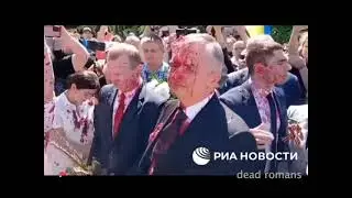 Russian Ambassador doused in blood red paint as protesters mob him in Poland