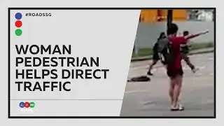 Woman Pedestrian Helps Direct Traffic After Traffic Lights Stop Working