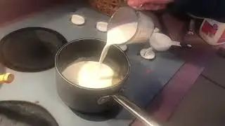 Adding milk to the Béchamel sauce