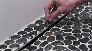 Laying sea pebbles in the shower. Laying, gluing, epoxy grouting.