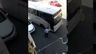 Wide bus in narrow street closed by a car in Jordan