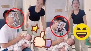 Dad put mom's picture on his head in order to nurse his baby! Don't you say that's a good trick!