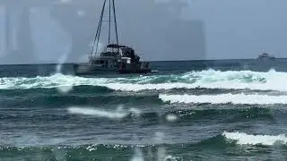 Man doing backflip off a boat out at sea. 