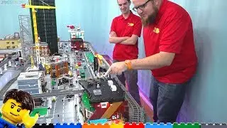 Guys in shirts point at LEGO