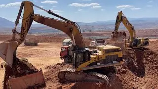 Two Caterpillar 365C Excavators Loading Trucks