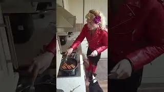 Crossdresser cooking sausages