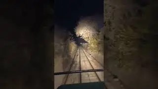 Live from train driver cab scary view of train at night in mountains 