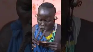 Woman from Surma tribe inserts lip plate | Omo Valley Ethiopia 