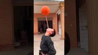 How this boy is swinging a basketball with a wooden stick