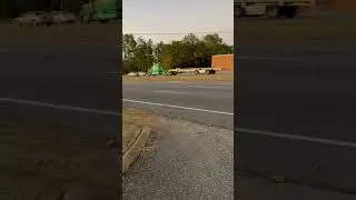 Green Stretched out Western Star with nice spread axle flat bed