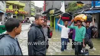 Villagers wade through flood waters in Kishanganj, Bihar