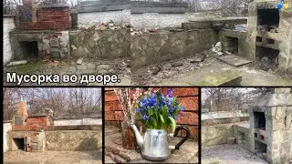 Trash cleaning in the yard. Development of the site of a rented house.