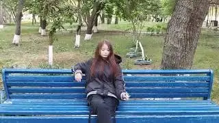 Girl smoking on bench in public  and crush her cigarette