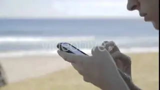 Using Mobile Phone On Beach - Stock Footage