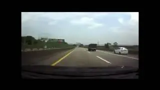 Speeding Yaris hits highway barrier twice w slow mo
