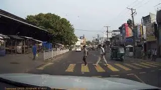 Just another day in Sri Lankan traffic - tuks on the pavement and a jaywalker