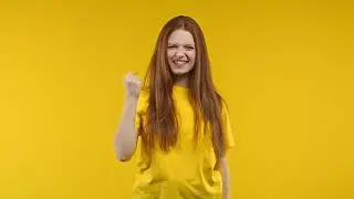 Pretty woman shows triumph yes yeah gesture of victory, achieved result, goals  Girl glad, happy, su