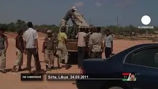 Libyan fighters fire from improvised MLRS and mortars of a position of supporters of Gaddafi