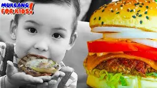 Hungry asian boy eating burger during lunch, holding large piece of meat in his hands! #eatingshow