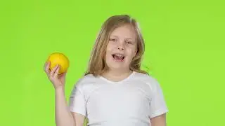 Little Girl Is Holding a Lemon and Sniffing It Green Screen Video Effect | No Copyright Stock Video