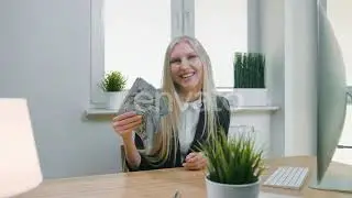 Smiling Business Woman Holding Wad of Cash. Beautiful Happy Blond Female Sitting in Office at | ...
