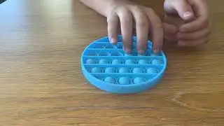 Kid farts while trying to film ASMR with fidget toys