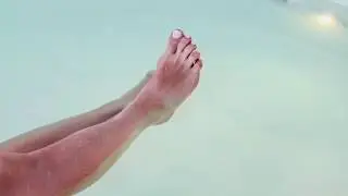 Girl with beautiful feet relaxing in a pool!  Feet worship!