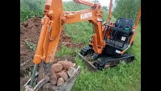 Мини экскаватор роет траншею под кабель
