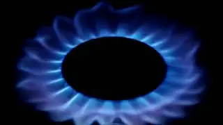 High quality closeup shots. Natural gas inflammation in stove burner, view on black background.
