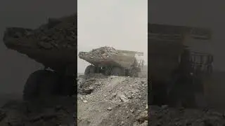 The roar of a Komatsu 785 engine when dumping a load