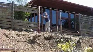 Timelapse of vern working on his fence above the steep bank