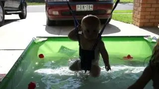 Little girl and Baby Madison and Hayley playing in their kiddie pool