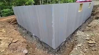 Foundation foam done and cement board being applied prior to backfilling.