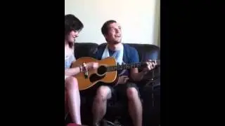 Dack playing guitar one handed with Tiffany
